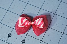 a red and white bow on a ruler