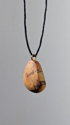 This is a handcrafted birch wood pendant made from locally recycled wood. This pendant features a beautiful and unique pattern caused by the natural decay of birch wood, as well as a hand sculpted design to complement it. The result is a timeless, breathtaking and organic piece of jewelry that suits women, men and children for almost any occasion or simply everyday life. I make these using only naturally fallen wood that I find on walks through my local forests - occasionally in the company of m Artisan Necklaces In Natural Wood As Gift, Artisan Necklace In Natural Wood As A Gift, Handmade Wooden Necklace Gift, Engraved Natural Wood Necklace As Gift, Engraved Natural Wood Necklace For Gift, Handmade Natural Wood Pendant Jewelry, Unique Natural Wood Pendant Jewelry, Artisan Natural Wood Necklace As A Gift, Artisan Natural Wood Necklaces For Gift