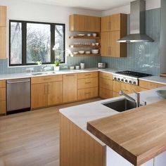 a modern kitchen with wooden cabinets and stainless steel appliance in the center island