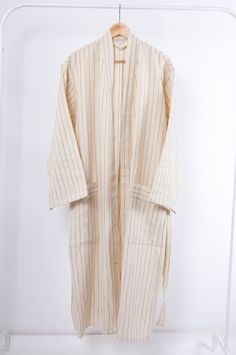 These natural beige striped robes are made from our handwoven linen/cotton peshtamals. They are soft, extremely absorbent, quick-drying and multifunctional. Use as bathrobe after shower, as cardigan at breakfast in the morning or worn as a duster jacket over jeans. Materials are cotton and linen. All of our robes are unisex. Care Instructions Please wash it before the first usage. They are machine washable but only at a cold temperature. Never use bleach or fabric softener. We recommend that han House Wear, Cotton Loungewear, Duster Jacket, Closet Essentials, Shades Of Beige, Natural Fabric, Bridesmaid Robes, Boho Gifts, Natural Fabrics