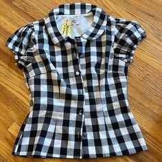 Women’s Black And White Buffalo Plaid Gingham Rockabilly Collared Blouse. Cute Round Buttons Down The Front. Elastic At Arms For Stretch. Purchased From Unique Vintage. New With Tags. Size Large. Approximately 15 Inches Laying Flat Across At Waist. Classic Fitted Plaid Tops, Summer Picnic Fitted Blouse, Fitted Summer Blouse For Picnic, Fitted Short Sleeve Tops For Picnic, Fitted Short Sleeve Tops In 1950s Style, Fitted Plaid Button-up Blouse, Fitted Casual Plaid Blouse, Fitted Plaid Shirt For Spring, 1950s Style Fitted Short Sleeve Tops