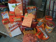 an assortment of snacks and candy on a counter top with notes attached to the bags