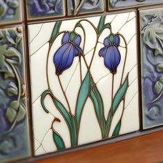 decorative tiles with blue flowers and leaves on them