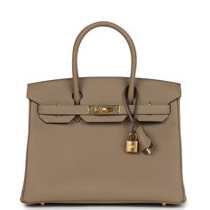 This Birkin is in Beige Marfa togo leather with gold hardware, tonal stitching, front flap, two straps with center toggle closure, clochette with lock and two keys, and double rolled handles.The interior is lined with Beige Marfa chevre and has one zip pocket with an Hermes engraved zipper pull and an open pocket on the opposite side.Collection: WOrigin: FranceCondition: New and never worn (plastic on hardware) Accompanied by: Hermes box, Hermes dustbag, clochette, lock, two keys, clochette dust Luxury Everyday Calf Leather Bag With Lock, Office Togo Leather Bag With Lock, Gold Epsom Leather Bag With Lock, Timeless Bags With Metal Hardware And Togo Leather, Beige Birkin Bag, Designer Togo Leather Bag With Metal Hardware, Timeless Togo Leather Bag With Lock, Elegant Togo Leather Bags With Metal Hardware, Timeless Togo Leather Bag With Metal Hardware