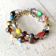 Beaded Bracelet filled with Vintage & New Inclusions in your color choice of Rainbow or Warm Neutrals. The colorful Rainbow option features silver metal spacer beads for a bit of light reflecting sparkle, while the Warm Neutrals option uses bronzy metals. Each one is an absolute One of a Kind filled with beads from yesterday and today! The bracelets measure about 7 1/4- 7 1/2 inches with an extra inch via a tonal extender chain for adjustable wear with a plated lobster clasp closure.  Stand out Multi-strand Bracelets With Colorful Beads For Jewelry Making, Nickel-free Multicolor Beaded Bangle Bracelets, Multicolor Multi-strand Beaded Bracelets, Everyday Multicolor Beaded Chain Bracelets, Multi-strand Czech Glass Bracelets As Gift, Colorful Beads Double Strand Bracelet As Gift, Multicolor Multi-strand Bracelets With Faceted Beads, Nickel Free Multi-strand Bracelets For Jewelry Making, Adjustable Double Strand Bracelets With Colorful Beads