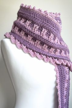 a crocheted scarf on top of a mannequin