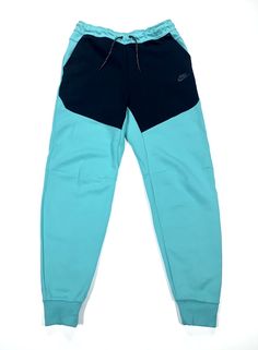 Elevate your activewear collection with these Nike Sportswear Tech Fleece Joggers Pants in a stylish washed teal and black color combination. The pants are designed with a drawstring closure, elastic waist, taped seams, and adjustable waist for a comfortable and breathable fit. The cotton blend material and fleece fabric type make it perfect for fall, winter, and spring seasons. These pants also come with easy care, zip pocket, pockets, and slim fit features that make it ideal for gym and traini Green Sportswear Bottoms For Outdoor Activities, Nike Sports Pants For Sports Season, Nike Joggers For Outdoor Sportswear, Nike Sportswear Joggers For Outdoor, Nike Outdoor Sportswear Joggers, Nike Green Jogging Bottoms, Nike Green Bottoms For Outdoor Activities, Nike Green Bottoms For Outdoor, Nike Sports Pants With Comfort Waistband