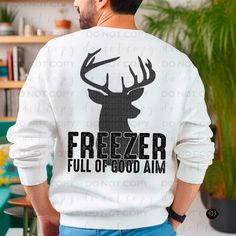 a man wearing a sweatshirt with the words freezer full of good aim printed on it