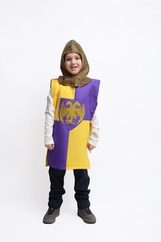 a little boy dressed in a knight costume