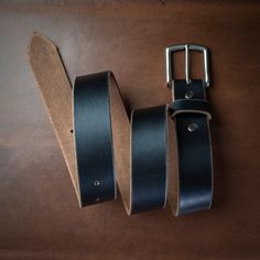 A Leather Belt Made with Care and Intention.Wear this black leather belt in the boardroom, at the pub, or while zip-lining through a forest canopy. Our full-grain leather provides a comfortable fit and our lifetime guarantee means decades of use. As soon as you pick up your belt you will know what quality and craftsmanship feel like. This is something you can't find in a big box store.Our full-grain leather develops a rich patina and fits better over time. We take the time to burnish and polish Horween Chromexcel, Zip Lining, Forest Canopy, Box Store, The Pub, Black Leather Belt, Brass Buckle, Black Belt, Full Grain Leather