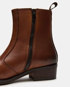 These BOONE ankle boots feature a luxurious leather upper and a convenient pull-on construction with an inside zip and pull tab for easy on-and-off access. The square toe design adds a touch of sophistication to this versatile and comfortable boot. Upgrade your footwear game with this timeless and versatile boot. 1.75 inch heel height 12 inch shaft circumference 6.5 inch shaft height Leather upper material Textile and synthetic lining Textile and synthetic sock Rubber sole Imported Brown Leather Mid-calf Boots With Zipper, Brown Zipper Closure Boots For Work, Modern Business Boots With Zipper Closure, Business Chelsea Boots With Zipper For Fall, Fall Business Chelsea Boots With Zipper Closure, Modern Leather Moto Boots With Zipper, Classic Brown Boots With Zipper Closure, Business Boots With Zipper For Fall, Business Chelsea Ankle Boots With Zipper