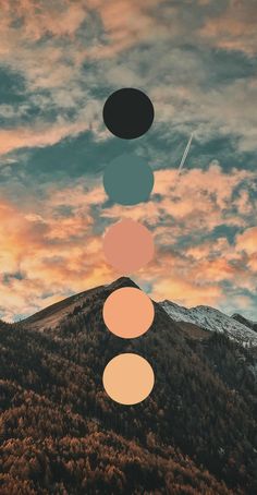 the sky is full of clouds and there are five circles above it, with mountains in the background