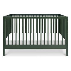 a green crib with white sheets on the bottom and side rails, in front of a