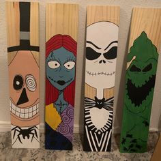 three skateboards decorated with cartoon characters on them