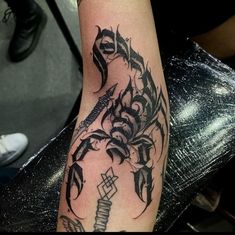 a black and white tattoo design on the arm