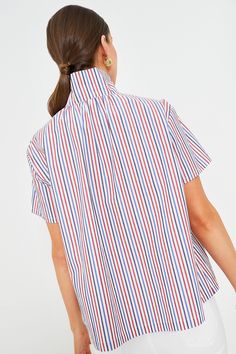 The Red and Blue Stripe Finn Popover is a sophisticated, easy, and flattering style all wrapped into one. Featuring a stand collar, partial front button closure, and pleating along the shoulders, this classic silhouette can be worn over and over again. Pair with ballet flats for the office, or with denim and sneakers for a casual day out and about. Stand collar Short sleeves Partial front button placket Relaxed body Material: 100% Cotton Care: Hand wash cold, do not bleach, hang to dry, low iron Casual High-neck Blouse For Workwear, Casual High Neck Blouse For Workwear, Spring Tops With Striped Fold Down Collar, Red Stand Collar Top For Spring, Blue High Neck Top For Work, Blue High Neck Top For Workwear, Red Top With Striped Collar For Spring, Red Spring Top With Striped Collar, Blue Summer Top With Fold Down Collar