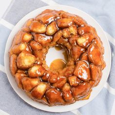 a bundt cake covered in caramel sauce on a white plate