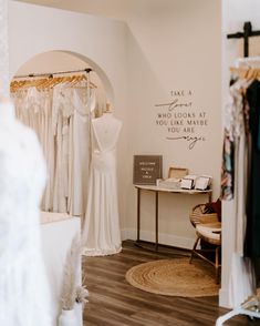 a wedding dress shop with mannequins and dresses