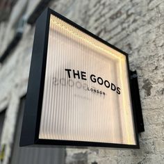 the goods store sign is lit up outside