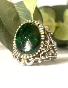 This vintage statement ring features a substantial silver tone band and setting. This ring has a dark green faux stone cab. The dark green cab has some scratching on it. Please see this in the photos. This ring is a size 5.  Please be aware that we are not jewelry experts. We have a sincere love of all things vintage especially vintage jewelry. We hope to share our finds with you. That being said, we describe our items to the very best of our ability. Please view all photos and know that each phone or computer screen may display slightly different colors. Please ask any and all questions. We gladly accept returns and provide shop credit or refund upon receiving the item back. The buyer pays return shipping unless the item is grossly damaged. In that case, please send us a photo of the dama Green Jewelry, Faux Stone, Green Stone, Statement Ring, Rings Statement, Statement Rings, Dark Green, Vintage Jewelry, Silver Tone