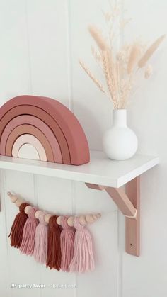 a shelf that has some pink and white items on it with the words pretty in pink above it