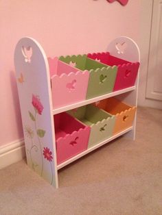 a child's toy shelf with flower designs on it