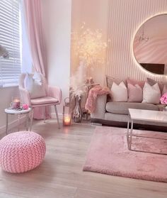 a living room filled with furniture and pink accents