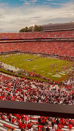 a stadium filled with lots of people watching a football game