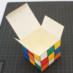 a rubik cube is sitting on top of a cutting board and it's open