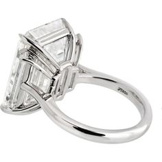 Discover the confluence of artistic legacy and contemporary creativity with this mesmerizing 15-carat Emerald Cut Diamond Engagement Ring. At the heart of this masterpiece is a breathtaking 15.30-carat emerald-cut diamond, certified by GIA, showcasing an I color grade and internally flawless (IF) clarity. This diamond is a true marvel; its large table and elongated facets create a dance of light that reveals an inner fire, often overshadowing the subtle hints of color within. The I color grade, Luxury Gia-certified Platinum Diamond Ring, Luxury Gia Certified Emerald Cut Diamond Ring, Luxury Gia Certified Diamond Engagement Ring, Emerald Cut Diamond Engagement Ring, Emerald Cut Diamond Engagement, Yellow Rings, Yellow Jewelry, Emerald Cut Diamond, Ring Watch