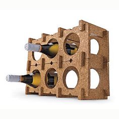 three bottles of wine are placed in a wooden block with holes on the side and one is empty