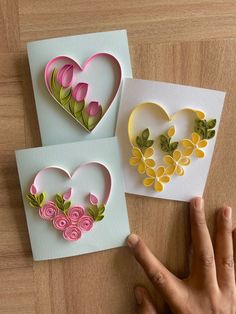 three handmade greeting cards with flowers and hearts