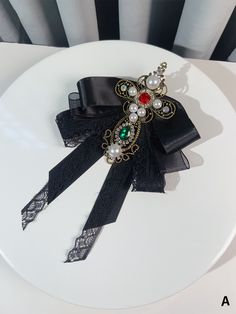 Elevate your outfit with our stunning Baroque-inspired Beads and Rhinestones Brooch or Bow Tie. Available in a striking black or red color, this exquisite accessory features intricate detailing and a cross design, adding a touch of vintage glamour to your look. Whether you choose to adorn your lapel or collar with this statement piece, it's the perfect way to showcase your unique style.   Please note that this product includes only one brooch or bow tie. Elegant Rhinestone Brooch For Party, Elegant Embellished Evening Brooch, Gothic Brooch Jewelry For Parties, Gothic Party Brooch Jewelry, Black Brooch Jewelry For Party, Black Party Jewelry Brooch, Red Beaded Brooch For Party, Tie Brooch, Cross Bow