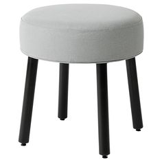 a round stool with black legs and a light gray upholstered cushion on top