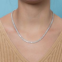 The Diamond Tennis Necklace is a piece of jewelry that features multiple diamonds set in a line or pattern, attached to a necklace. This specific necklace has a total carat weight of 20.00 carats. The diamonds are set in a 3-prong setting, which is a popular choice for displaying the diamonds in a way that minimizes the amount of metal around the diamonds, giving them a more open and airy appearance. The diamonds are 4.00 mm in size and the necklace is made of 14K gold, which is a popular type o Luxury Diamond Cut Sterling Silver Tennis Necklace, Luxury Classic Tennis Necklace With Bezel Setting, Luxury Tennis Necklace With Vvs Clarity As A Gift, Luxury Dazzling Cubic Zirconia Tennis Necklace, Luxury Women's Tennis Necklace With Single Cut Diamonds, Luxury Fine Jewelry Cubic Zirconia Tennis Necklace, Luxury Diamond Tennis Necklace For Formal Occasions, Luxury Round Single Strand Tennis Necklace, Luxury White Tennis Necklace For Formal Occasions