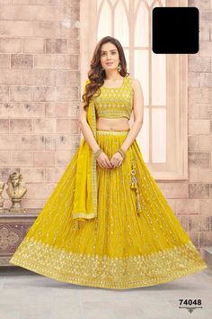 Like a sunbeam, she radiated in her sunshine yellow lehenga, the delicate gold zari embroidered buttas sparkling like rays of light on a cloudless day. The broad embroidered border seemed to shine with warmth, as if the very essence of happiness had been woven into the fabric. The zari embroidered sleeveless blouse added a touch of vibrancy, like the first bloom of summer. The simple tonal dupatta with embroidered border fluttered behind her like a gentle breeze on a sunny afternoon. Her beauty Yellow Semi-stitched Sets For Navratri, Yellow Sharara With Gold Embroidery, Yellow Sharara With Gold Embroidery For Festivals, Traditional Yellow Sharara With Gold Embroidery, Festive Yellow Sharara With Gold Embroidery, Yellow Lehenga Saree For Eid, Traditional Yellow Anarkali Set With Gold Embroidery, Yellow Anarkali Choli For Eid, Yellow Sets With Mirror Work For Eid