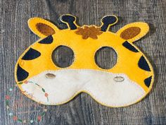 a giraffe mask is sitting on a wooden surface