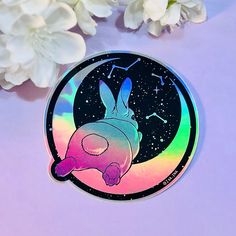 a sticker with an image of a rabbit in the sky and stars on it