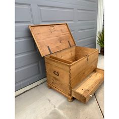 an old wooden chest sitting on the side of a garage