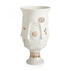 a white vase with gold details on the face and eyes is shown in front of a white background