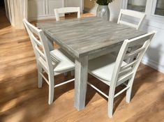 a table and chairs in a room with hard wood floors