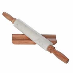 a large knife is on top of a wooden block with a white blade in it