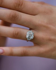 a woman's hand with a diamond ring on it