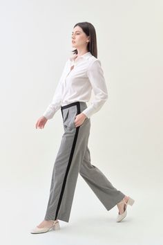 Combining classic tailoring with modern details, our Pleated Wide Pant offers an effortlessly sophisticated silhouette. With a comfortable mid-rise and a pleated wide fit, pair it with our Classic Blazer for a luxe statement. Details Hidden hook-and-bar closure Comfortable mid-rise Wide trouser fit, regular length Side pockets Contrast stripe detail Houndstooth suiting fabric upcycled from premium deadstock Machine washable Chic Wide Leg Pants For Office With Straight Hem, Chic Wide Leg Pants For Office, Classic Houndstooth Pants For Business Casual, Casual Wide Leg Pants With Straight Hem For Office, Classic Houndstooth Formal Pants, Classic Formal Houndstooth Pants, Modern Wide Leg Pants For Workwear, Modern Wide Leg Pants With Straight Hem For Office, Modern Wide Leg Work Pants With Straight Hem