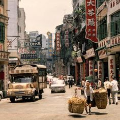 people are walking down the street carrying baskets