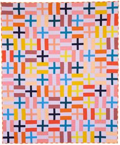 an abstract quilt made with squares and crosses in pink, blue, yellow, orange, and red