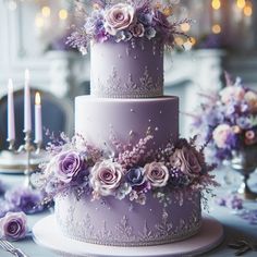 a three tiered cake with purple flowers and candles on the table next to it