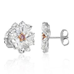 These 18k white gold diamond earring studs are feminine and truly one-of-a-kind. This design showcases 10.64ct of diamonds that are certified at G-I colors and VS2-SI2 clarities. The stunning heart shaped diamonds are styled as floral petals that are individually GIA certified, weighing in at just over 1 carat each. In the center of the design is a rare fancy pink diamond that is secured by rose gold prongs. These beauties are not only extremely unique but posess a beautiful allure that will mes Heart Shaped Diamond Earrings, White Gold Diamond Earrings, Gold Diamond Earrings Studs, Floral Studs, Diamond Earring, Gold Diamond Earrings, Heart Shaped Diamond, Earring Studs, Pink Diamond