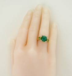 White & Canary Diamond Ring, Yellow Diamonds, Genuine Emerald Ring, Estate Ring, 18K Gold, Ring, Italian Ring, Genuine Diamonds, This gorgeous vintage ring is finely crafted in solid 18K Yellow Gold, made in Italy. The center Natural Emerald cabochon is 11x9mm (3.75 carats). This gem has some minor signs of wear which cannot be seen without magnification. Two natural fancy canary Diamonds are .45 carat each = .90 carat for two gems. Four small white bezel set diamonds total .12 carat; they a Green Multi-stone Emerald Ring Fine Jewelry, Fine Jewelry Green Multi-stone Emerald Ring, Classic Green Multi-stone Emerald Ring, Oval Multi-stone Emerald Gemstones, Green Multi-stone Emerald Rings, Luxury Green Oval Cluster Ring, Oval Yellow Gold Emerald Ring With Multi-stone, Exquisite Emerald Gemstones For Anniversary, Oval Yellow Gold Emerald Ring With Multiple Stones