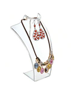 a clear display case with three necklaces and two earring holders on the bottom